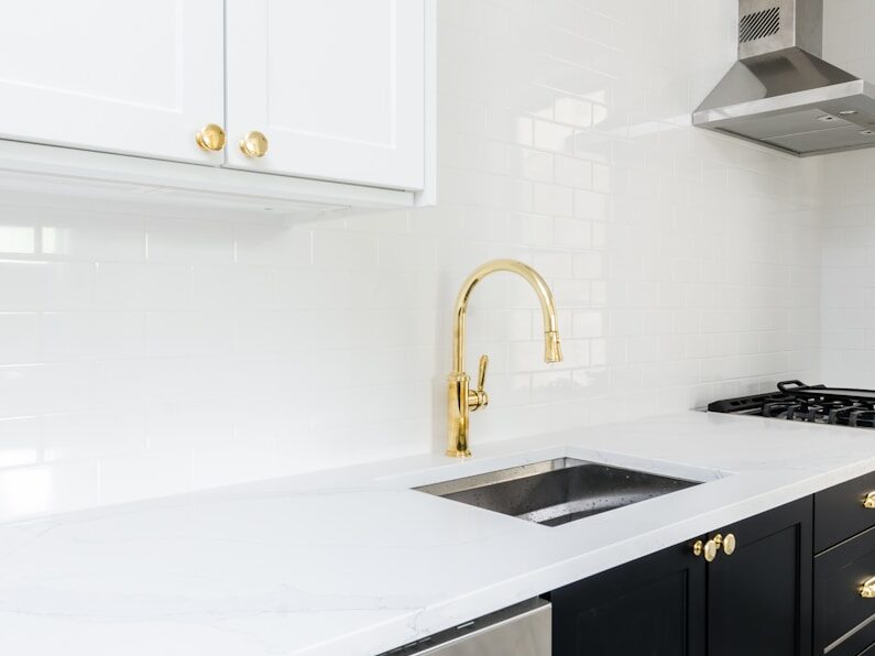 white wooden kitchen cabinet near white wooden kitchen cabinet