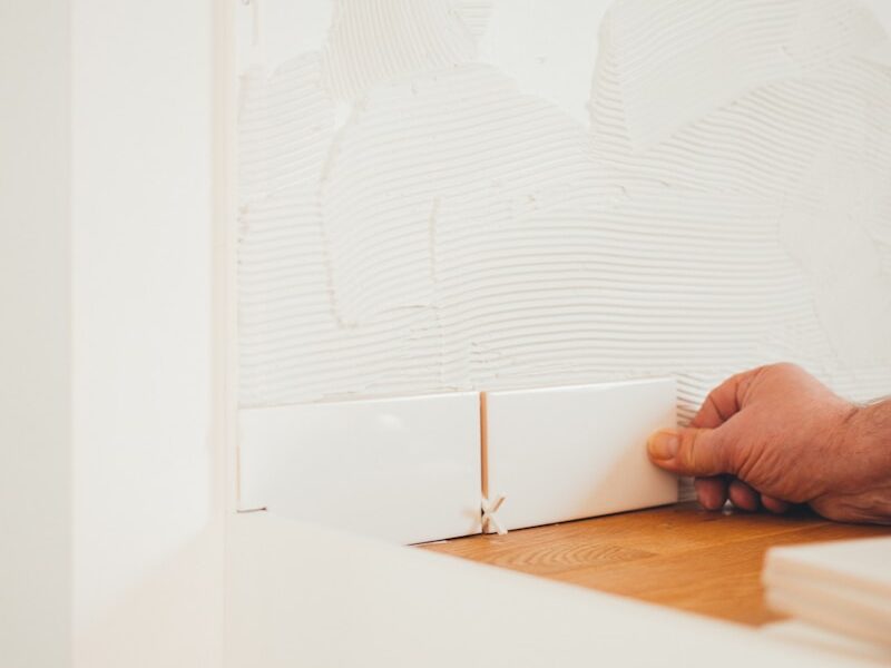 person holding white tile